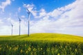 Eco green power station, wind turbines at the spring field Royalty Free Stock Photo