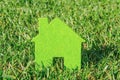 Eco house concept in green grass, green eco house icon in nature Royalty Free Stock Photo