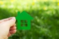 Eco house concept ,hand holding green eco house icon in nature Royalty Free Stock Photo