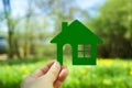 Eco house concept ,hand holding green eco house icon in nature Royalty Free Stock Photo