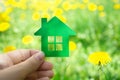 Eco house concept ,hand holding green eco house icon in nature Royalty Free Stock Photo