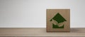 Eco House In Green Environment Wooden Home Friendly Icon on Wooden Block 3D Render Royalty Free Stock Photo