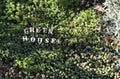 Eco house - inscription from wooden letters on natural background of green grass. Green eco friendly home, Zero waste