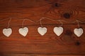 Eco linen fabric hearts on wooden background,Valentines Day concept design.Decorative white heart on jute twine garland Royalty Free Stock Photo