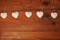 Eco linen fabric hearts on wooden background,Valentines Day concept design.Decorative white heart on jute twine garland Royalty Free Stock Photo