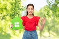 happy little girl with green house icon showing ok Royalty Free Stock Photo