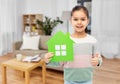 smiling little girl with green house icon at home Royalty Free Stock Photo