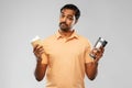 Man comparing thermo cup or tumbler and coffee cup