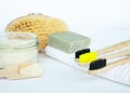 Eco natural bamboo toothbrush on white background with toiletries, natural soap, scrub, body brush and waffle towel Royalty Free Stock Photo