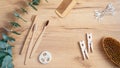 Eco natural bamboo toothbrushes, luffa sponge, spa brush, cotton ear sticks and eucalyptus leaf on wooden table. Flat lay, top Royalty Free Stock Photo