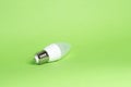 Eco power concept. LED bulb on green background. Copy space Royalty Free Stock Photo