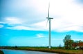 Eco power windmill farm in the countryside of The Netherlands. Wind turbines generating electricity station in open space green me