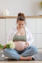 Eco pregnancy. Pregnant woman with big belly advanced pregnancy holding white flower hydrangea in hand at home. Healthy