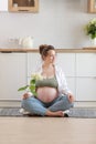 Eco pregnancy. Pregnant woman with big belly advanced pregnancy holding white flower hydrangea in hand at home. Healthy