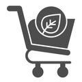 Eco shopping glyph icon. Ecology market trolley with leaf button. Commerce vector design concept, solid style pictogram Royalty Free Stock Photo