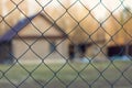 protected house behind wired fence Royalty Free Stock Photo