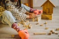 Eco-toys. The girl builds a tower out of a wooden construction kit Royalty Free Stock Photo