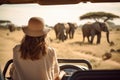 Woman tourist on a safari in Africa, traveling by car with an open roof. AI Generated