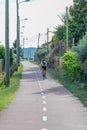 Eco view pedestrian / cycle lane, with cyclist pedaling and agricultural fields around