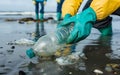 eco volunteers picking up plastic trash on the beach - Activist people collecting garbage protecting the planet - Ocean Royalty Free Stock Photo