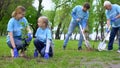 Eco volunteers working at city park, planting trees, nature care and protection Royalty Free Stock Photo