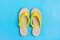 Eco yellow bamboo flip flops on blue background Flat lay, top view. Royalty Free Stock Photo