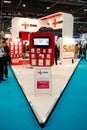 Visitors walk past an exhibitor booth