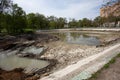 Ecological catastrophy. Drying lake in city park. Dry swamp lake disappears, idea and concept of environmental conservation, Royalty Free Stock Photo