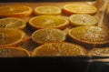 Ecological Christmas decorations. Drying of pieces of oranges and lemons in the oven Royalty Free Stock Photo