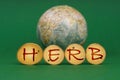 On a green background there is an Earth globe and wooden roundels with the inscription - Herb Royalty Free Stock Photo