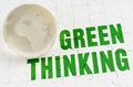 On white puzzles there is a glass globe and the inscription - Green Thinking