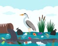 Ecological disaster of plastic waste in the river. A heron bird stands in a lake polluted with plastic debris and dead Royalty Free Stock Photo