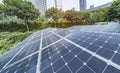 Ecological energy renewable solar panel plant with urban landscape Royalty Free Stock Photo
