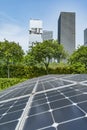 Ecological energy renewable solar panel plant with urban landscape Royalty Free Stock Photo