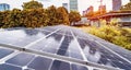 Ecological energy renewable solar panel plant with urban building landscape landmarks Royalty Free Stock Photo