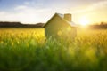 Ecological green wood  model house in empty field at sunset Royalty Free Stock Photo