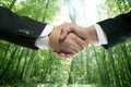 Ecological handshake businessman in a forest