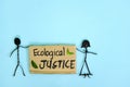 Ecological justice concept. People stick figures protesting while holding a carton placard.