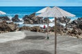 Ecological parasol made of bamboo in seascape with a man with his back watching the sea in Quatro Ribeiras, Terceira - Azores