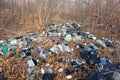 Garbage in the forest. Used plastic trash thrown into the forest. Royalty Free Stock Photo