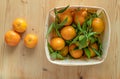 Ecological tangerine basket on a light wooden base