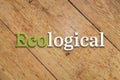 `Ecological` text on a wooden background.