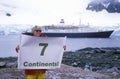 Ecological tourist from cruise ship Marco Polo with Seven Continents sign at Paradise Harbor, Antarctica Royalty Free Stock Photo