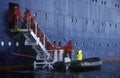 Ecological tourists enter inflatable Zodiac boat from cruise ship Marco Polo in Errera Channel at Culberville Island, Antarctica