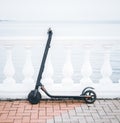 Ecological transport electric scooter on embankment in front of sea.