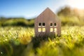 Ecological wood  model house in empty field at sunset Royalty Free Stock Photo