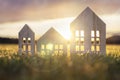 Ecological wood  model house in empty field at sunset Royalty Free Stock Photo