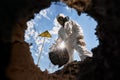 Ecologist digging pit by shovel and planting tree