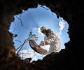 Ecologist digging pit by shovel and planting tree