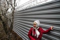 The ecologist Evgenia Chirikova near a fence of a cottage of the governor Tkachyov in the protected wood